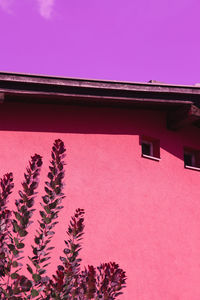 Low angle view of pink building against sky
