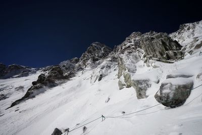 Scenic view of snow covered mountains against clear sky