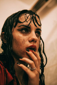 Close-up of wet young woman in bathroom