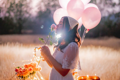 Midsection of woman holding balloons