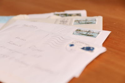 Close-up of envelops on wooden table