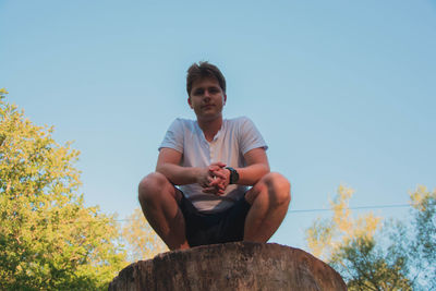 Low angle view of man against clear sky