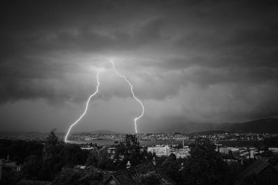 Thunderstorm with lightning strikes over lake zurich.