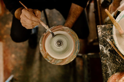 Cropped hand of man holding metal