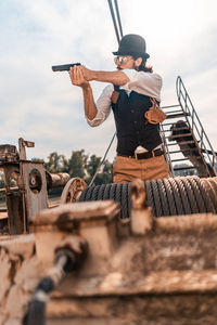 Low angle view of man standing against sky