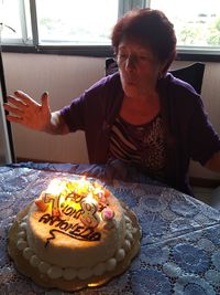 Midsection of woman with chocolate cake