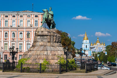 Statue of buildings against sky in city