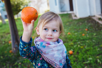 Portrait of young woman holding apple