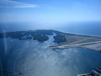 Aerial view of sea and landscape against sky