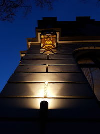 Low angle view of illuminated building against sky at dusk