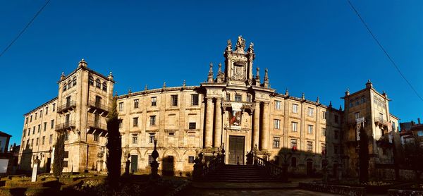 Low angle view of old building against blue sky