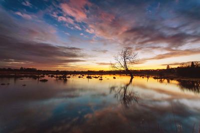 Scenic view of lake against sky during sunset