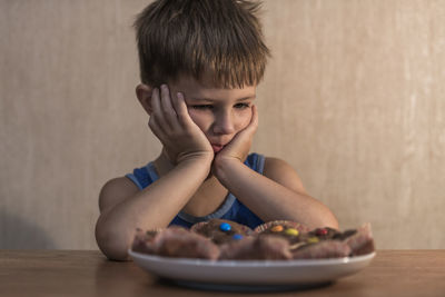 Portrait of boy sitting on table