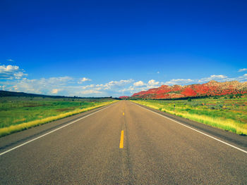 Empty road along countryside landscape