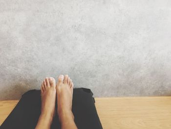 Low section of woman relaxing on floor