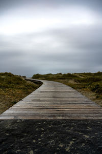 Empty road along countryside landscape