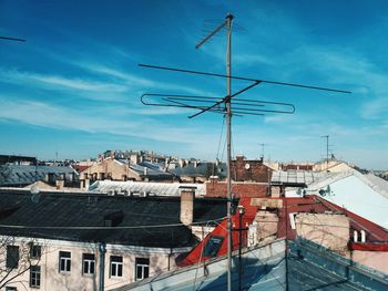 Buildings in city against blue sky