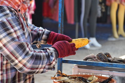 Midsection of man for sale at market