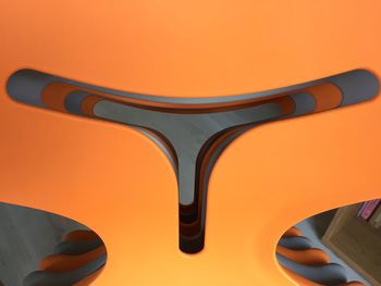 High angle view of electric lamp against orange background