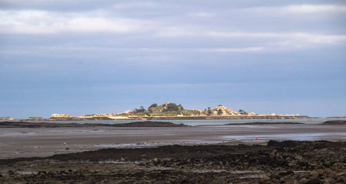 Scenic view of landscape against cloudy sky