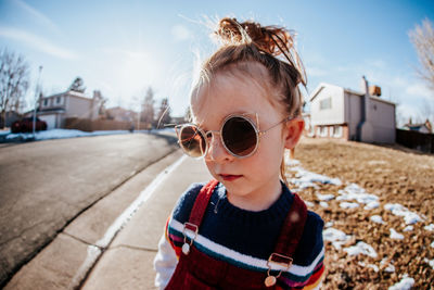 Close up of young child outside looking serious