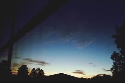 Low angle view of silhouette trees against sky at sunset