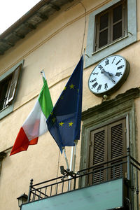 Low angle view of flags hanging from window