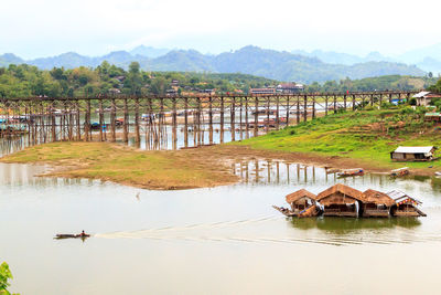 Morn bridge over lake against mountains