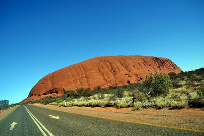 Empty road along rocky mountain