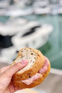 Close-up of hand holding sandwiches 
