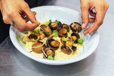 Midsection of person having food on table