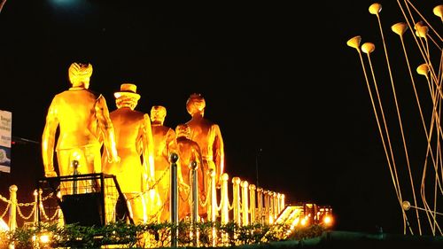 Illuminated built structure against clear sky at night