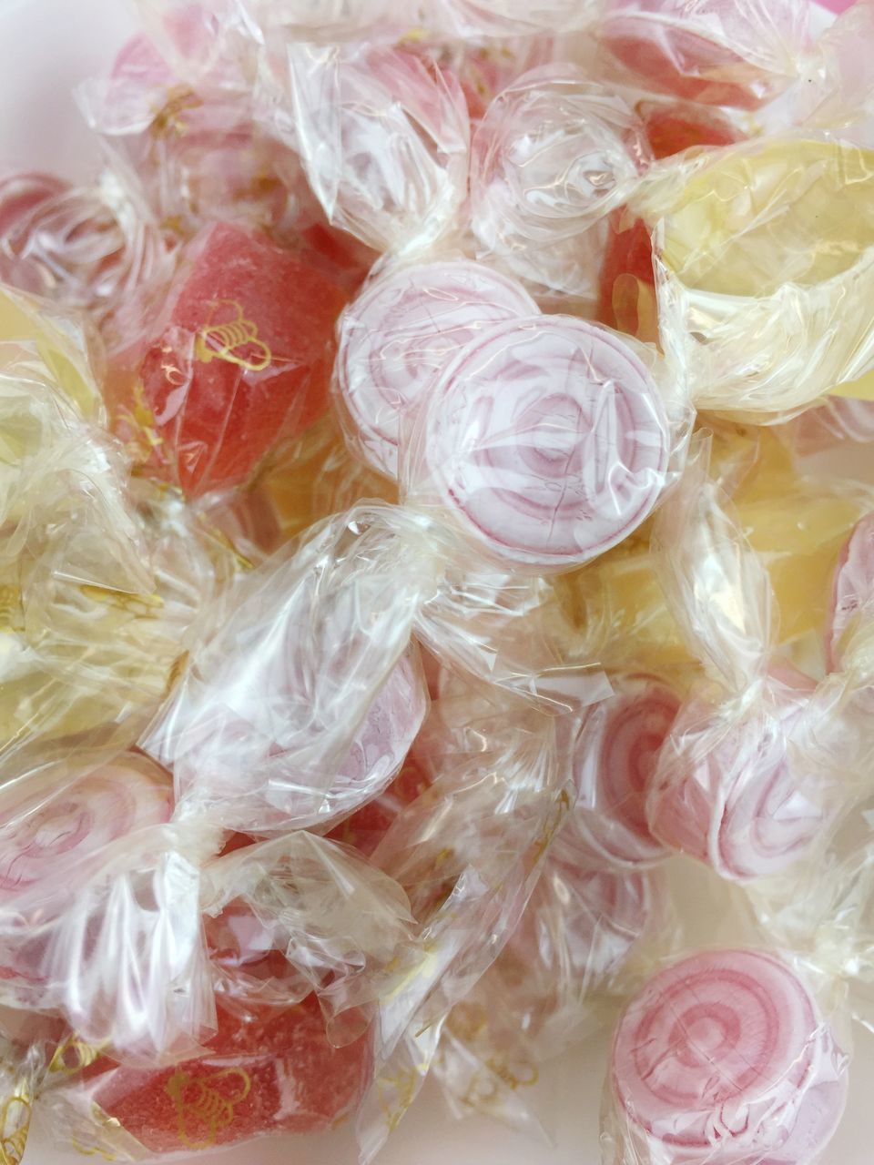 FULL FRAME SHOT OF MULTI COLORED CANDIES IN PLASTIC