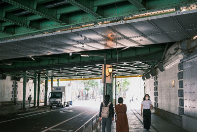 Rear view of people walking in city