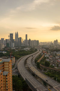 High angle view of bridges in city at sunset