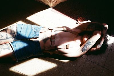 High angle view of young woman sleeping on floor