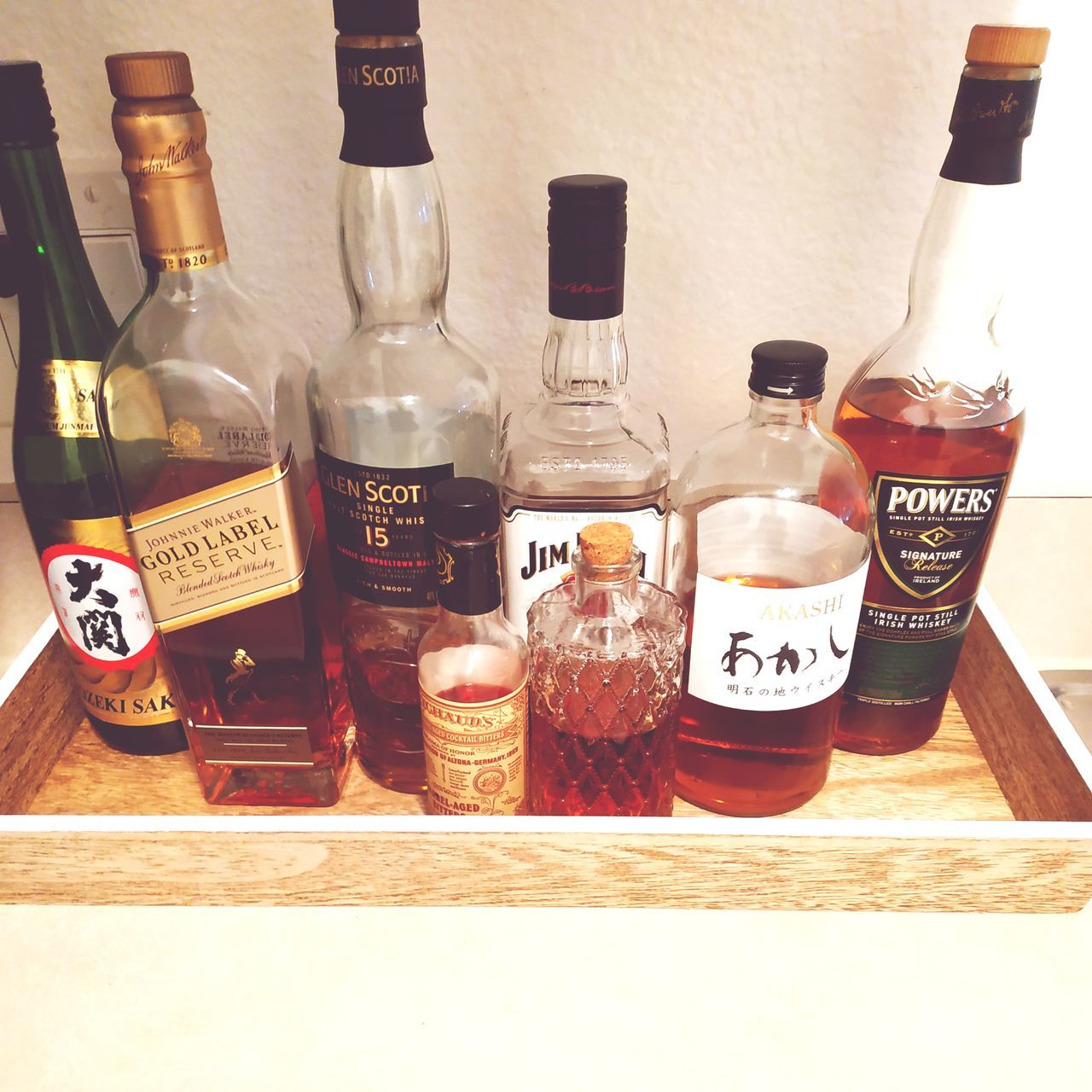 WINE BOTTLES ON GLASS TABLE