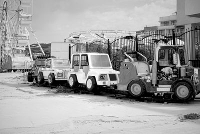 Cars on street against buildings in city during winter