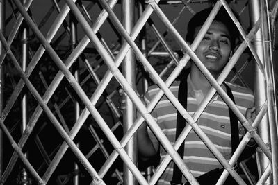 Portrait of man looking through window