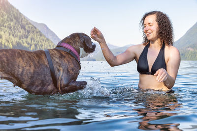 Young man with a horse in the water