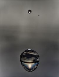 Digital composite image of bubbles in water against sky