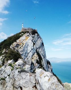 Low angle view of rock formation in sea against sky