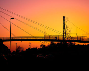 Silhouette bridge against sky during sunset