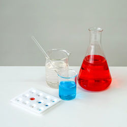 High angle view of chemicals in glassware on table