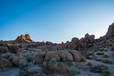 Rock formations in desert landscape against clear blue sky