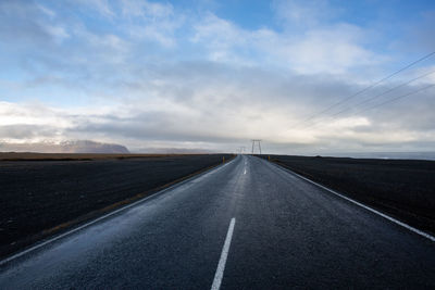 Road passing through landscape against sky