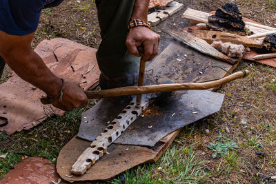 Low section of man working on wood