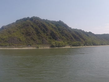 Scenic view of sea and mountains against sky