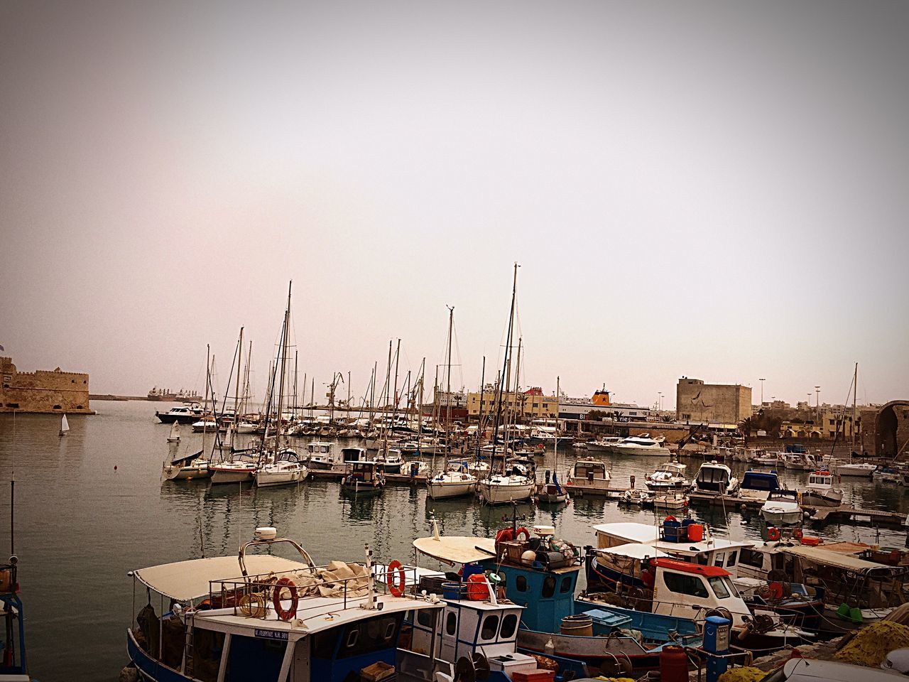 nautical vessel, transportation, mode of transport, moored, boat, harbor, clear sky, copy space, sea, water, sailboat, mast, city, sky, day, marina, tranquility, waterfront, no people, dock, development, modern