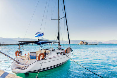 Boats in sea against clear sky